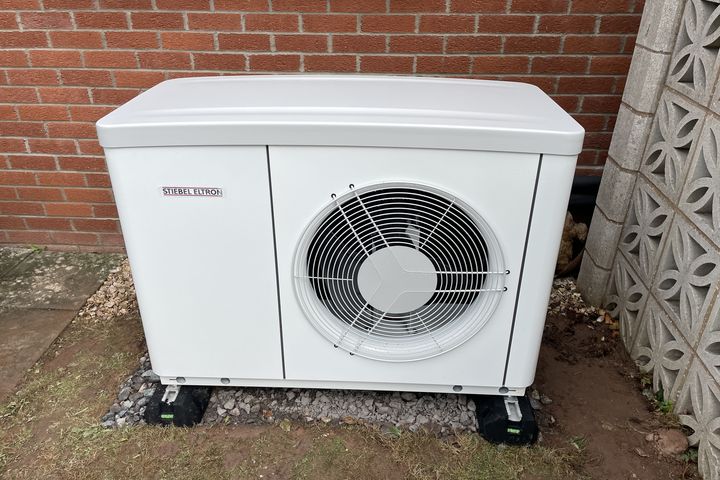 Air source heat pump fitted beside a modern bungalow in Knighton