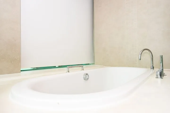 Minimalist white bathtub in a newly renovated bathroom
