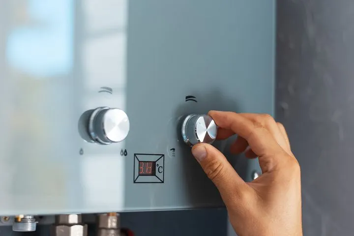 Modern combi boiler being adjusted during installation